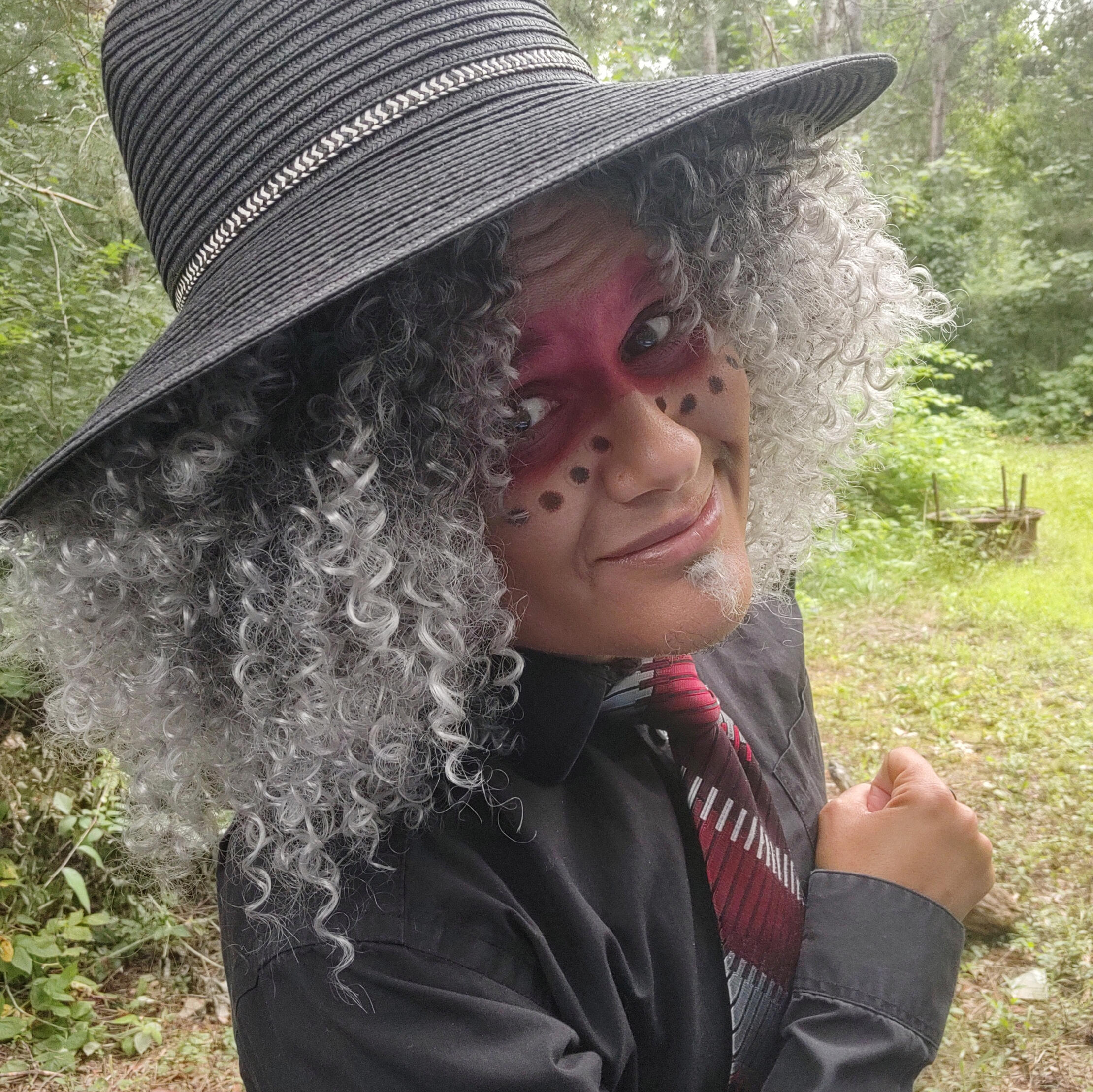 Tanamá Kao Tanamá Kao, an Afro-Indigenous Hispanic person with coily silver hair and stubble