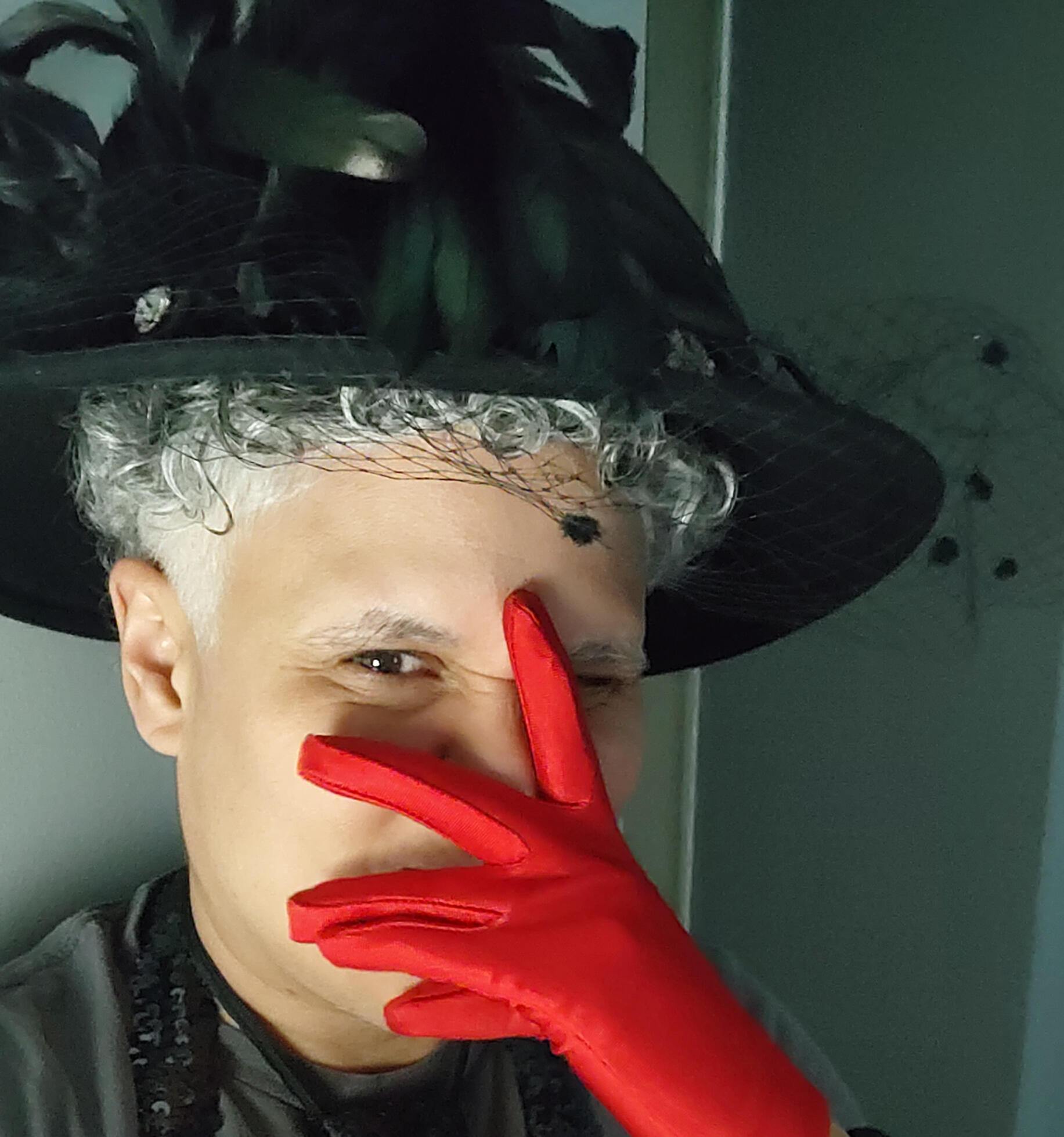 Tanamá Kao wearing red mask makeup with eight dots beneath.